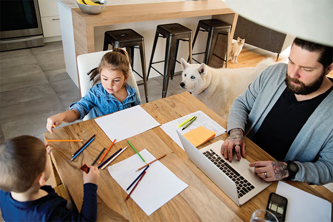 dad-on-computer-with-kids-at-table